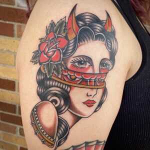 Tattoo of a lady head with a horizontal section splitting at the nose revealing the eyes of a demon