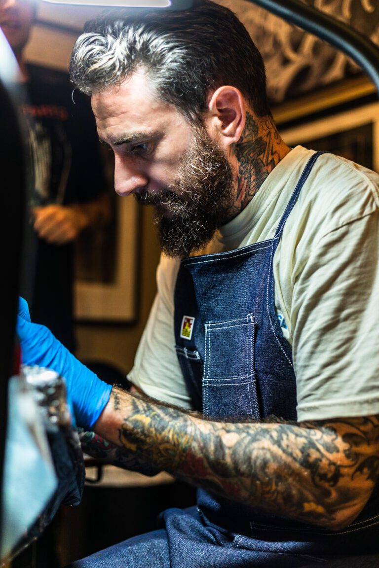 Action portrait of Darigo Bonatto tattooing
