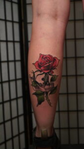 Neo-traditional styled skull and rose tattoo