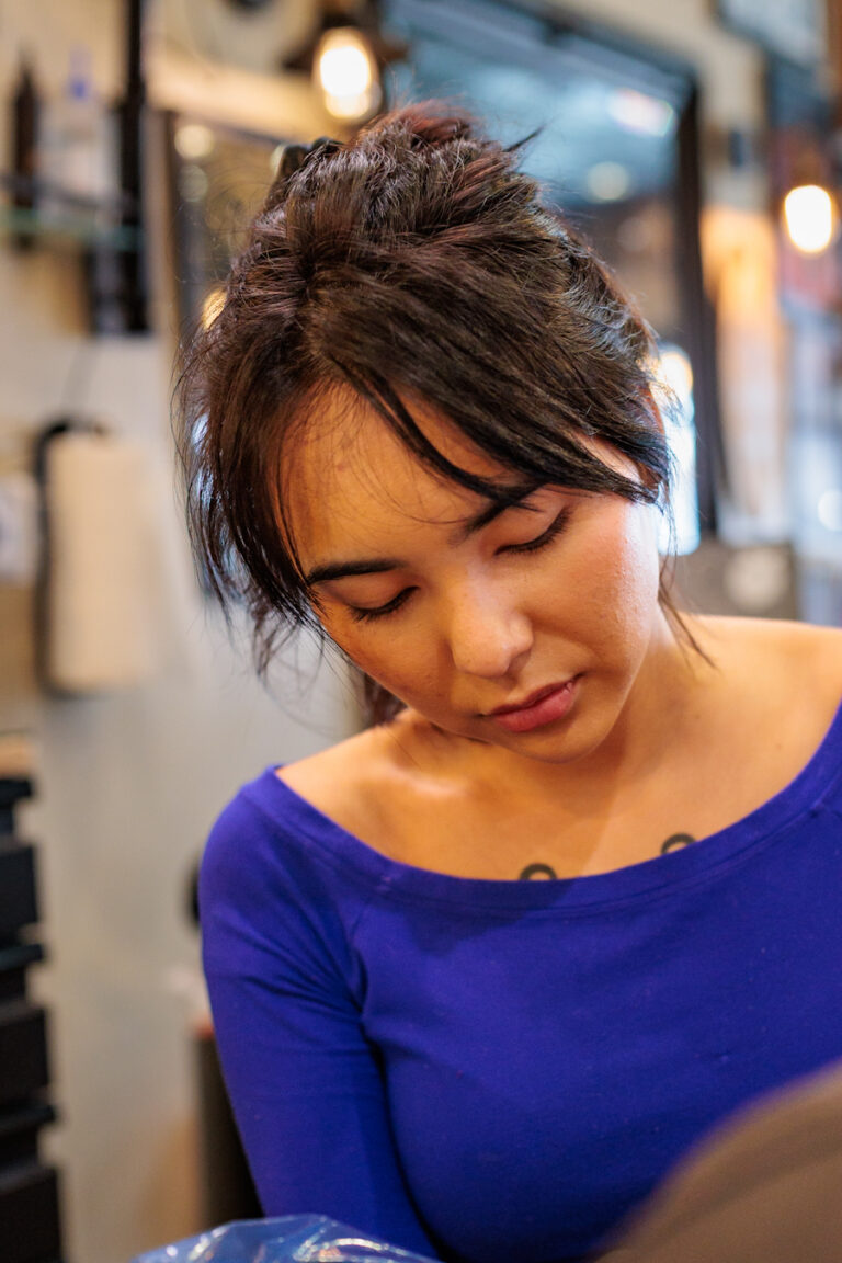 Jasmin T action portrait while mid-tattoo